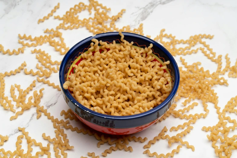 bowl with noodle noodles sits on an elaborate counter