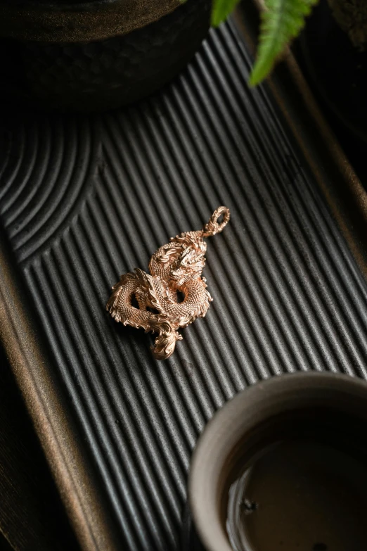 a tea tray is shown with a gold item on it