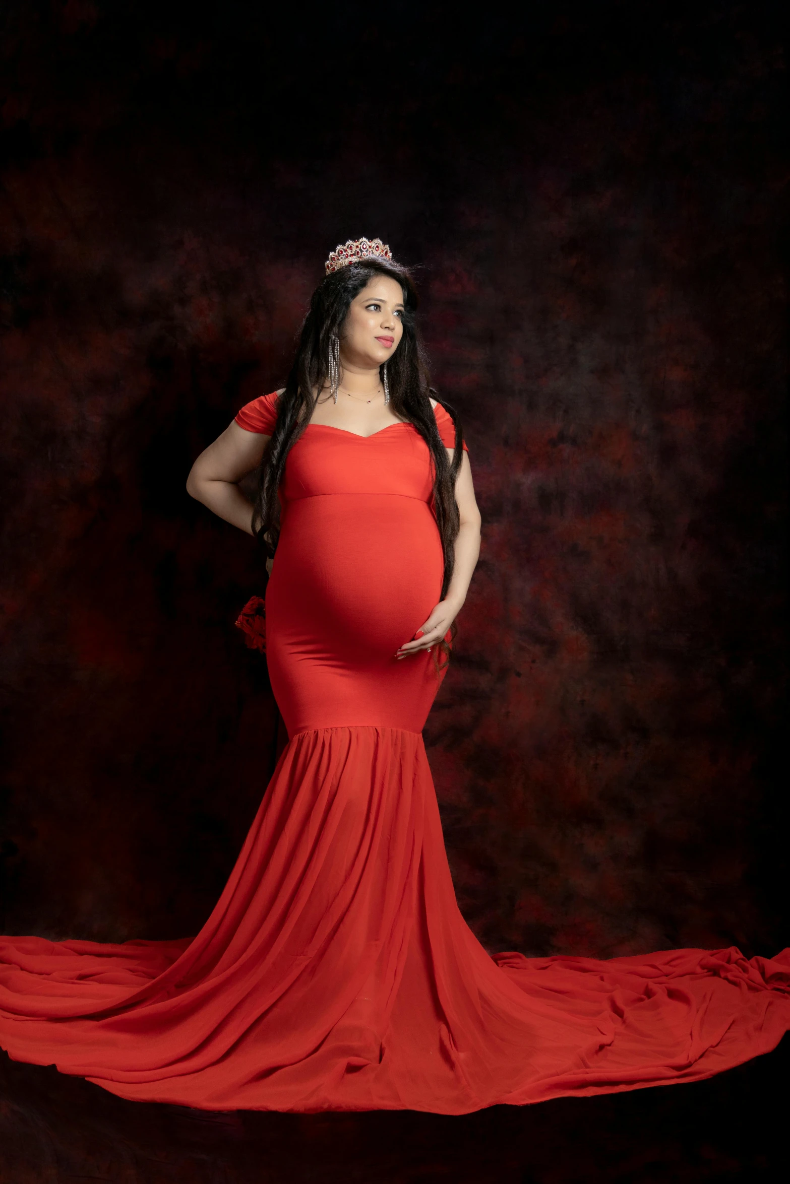 a woman in an orange dress posing for a po