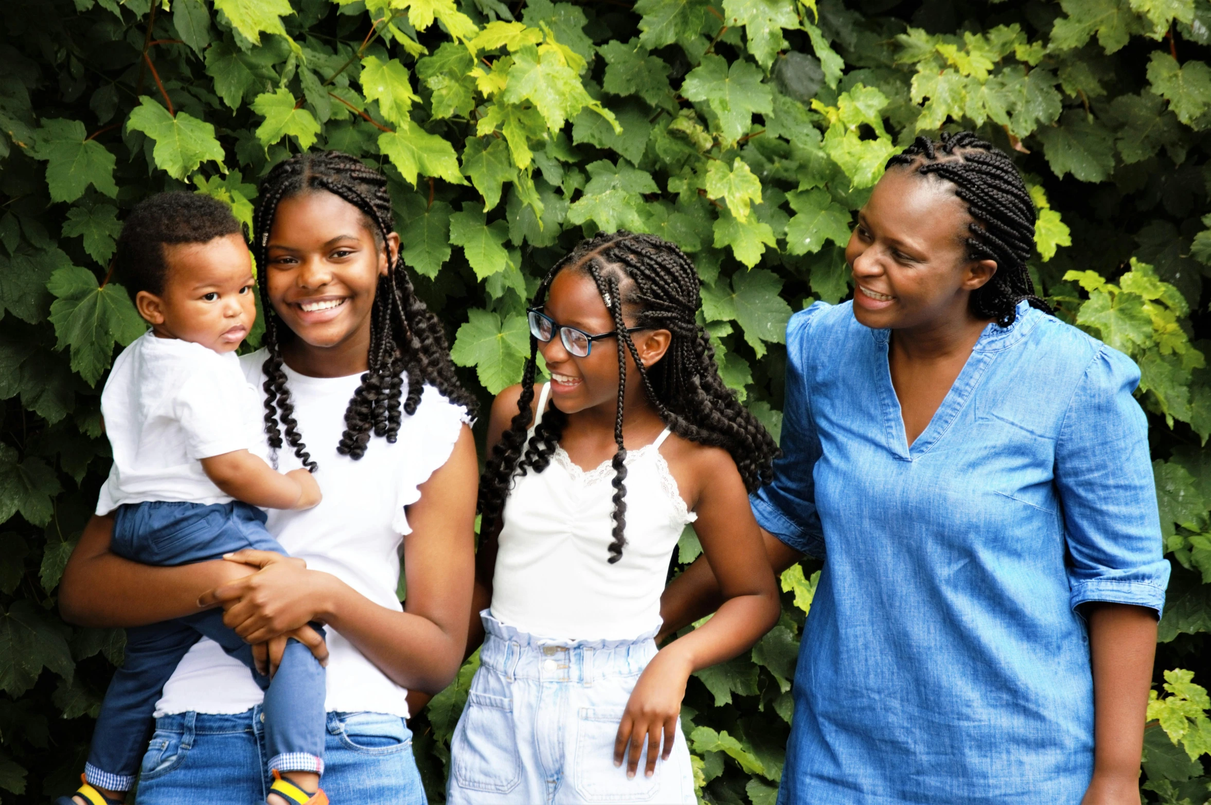 a family pose for a portrait with their son in the middle