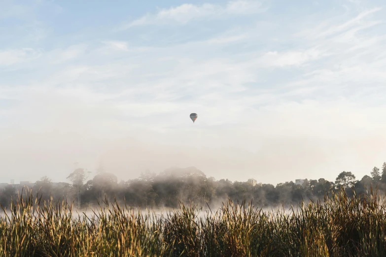 the  air balloon is flying low to the ground