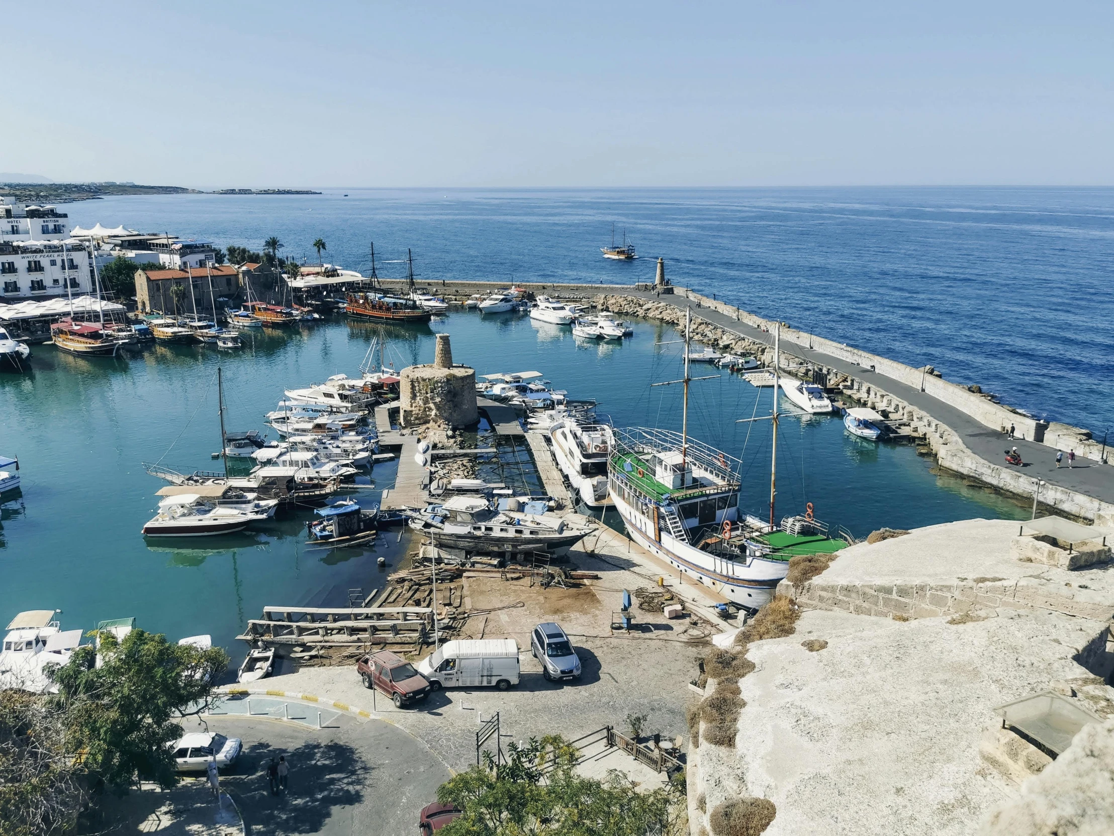 a marina is situated between many smaller boats