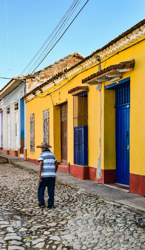 the woman is standing on the cobblestone road