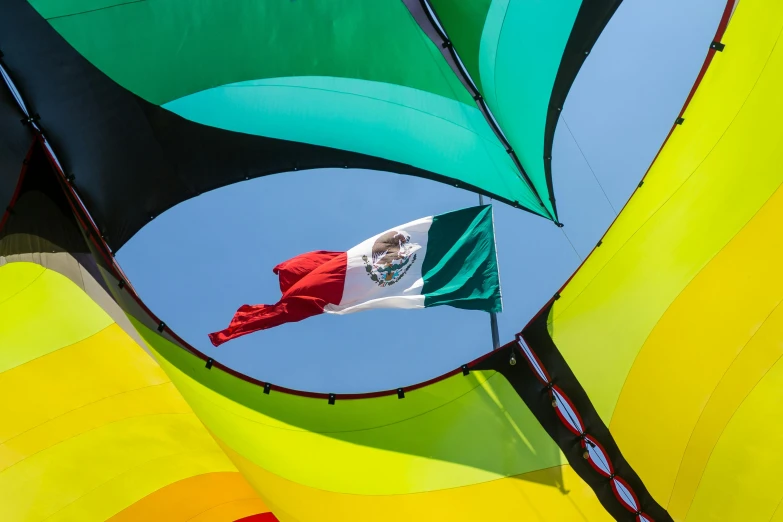 an american flag flying on the tail of a colorful boat