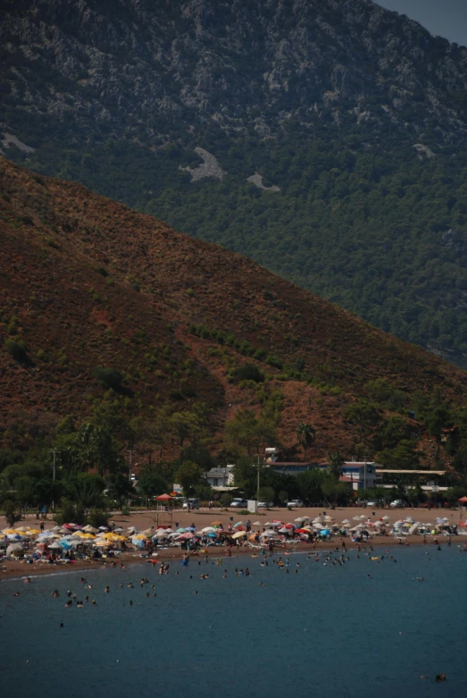 an ocean that has a lot of beach chairs and umbrellas on it