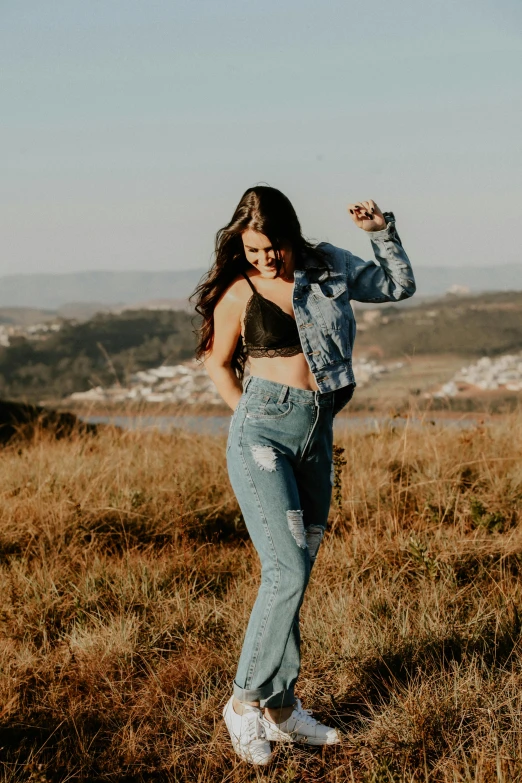 a young woman is standing outside and posing for a po