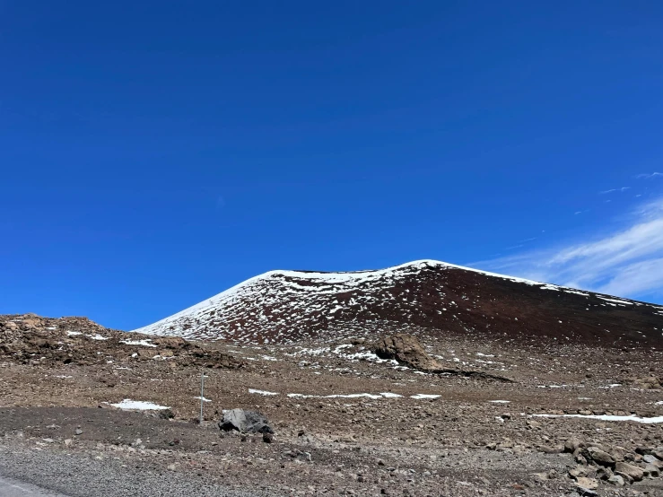 some hills on a desert plain with snow