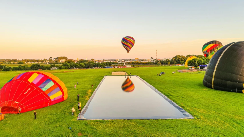 a pool of water that is surrounded by some  air balloons