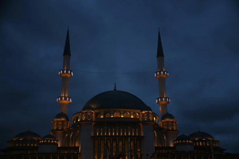 a white building with three tall black and yellow domes