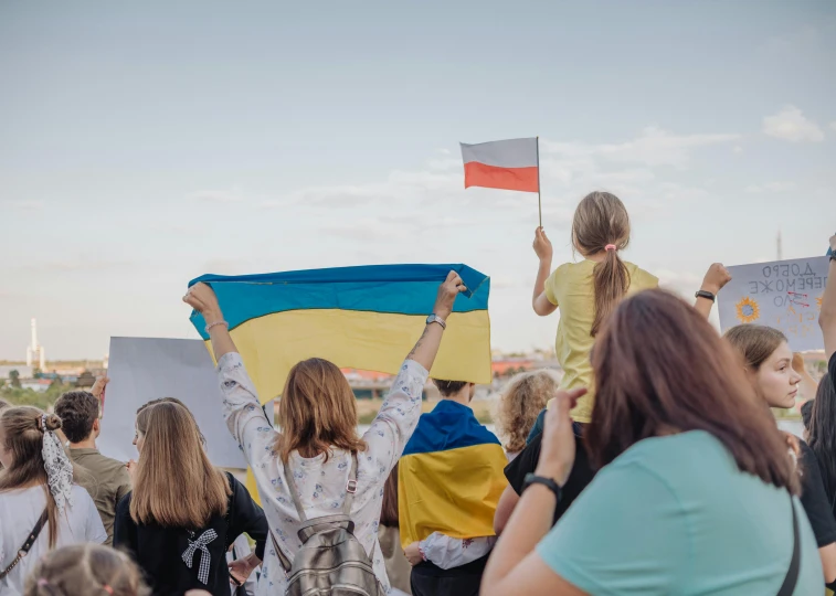 people holding up their flag during a demonstration