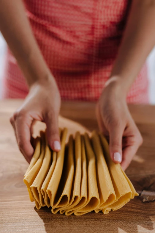 a person is holding several pieces of pasta