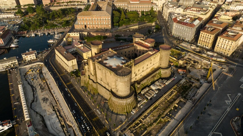 a large old castle sits next to other buildings