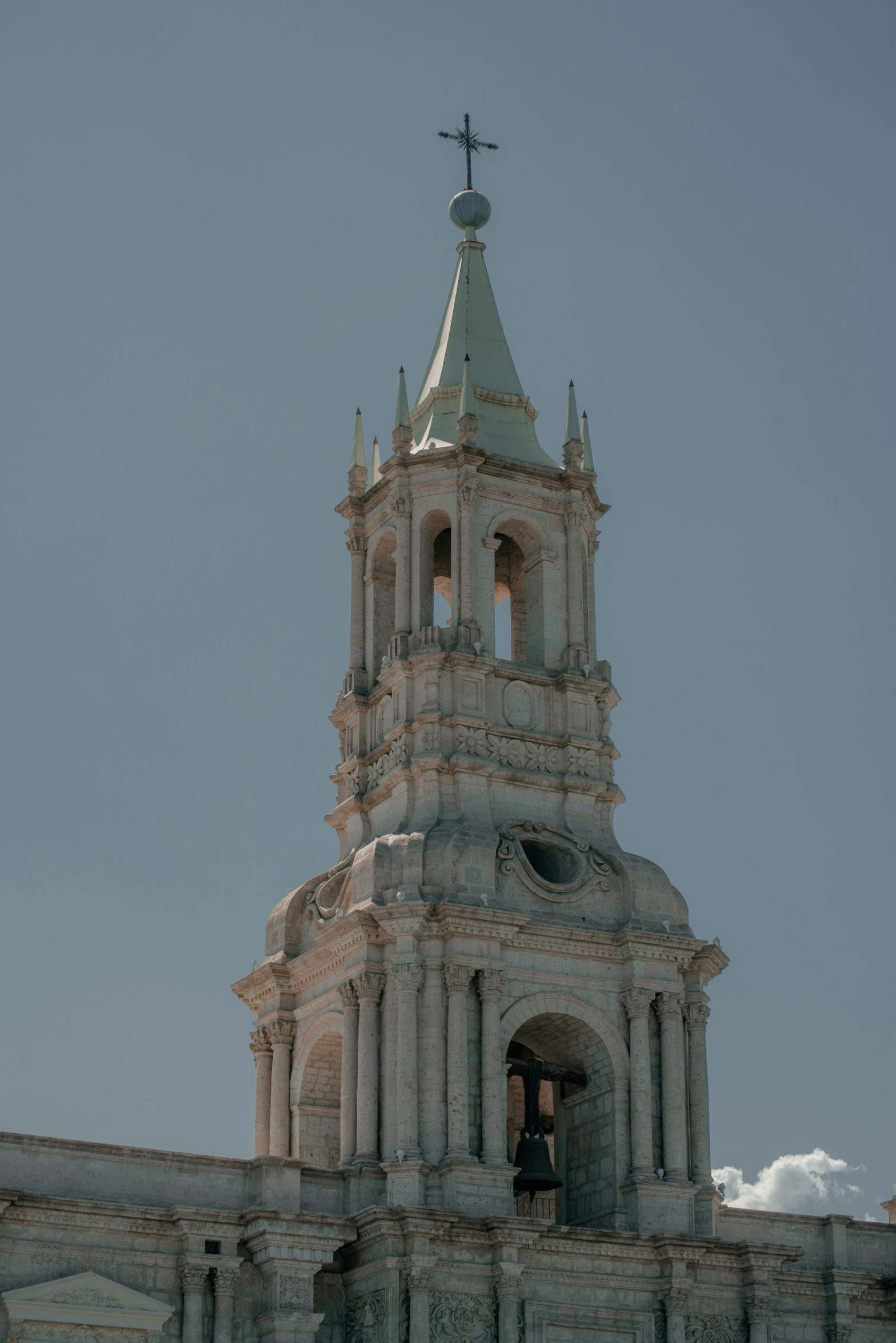 a large church bell tower with steeples and a person standing on the door