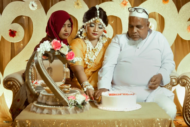 the indian couple is  the cake together