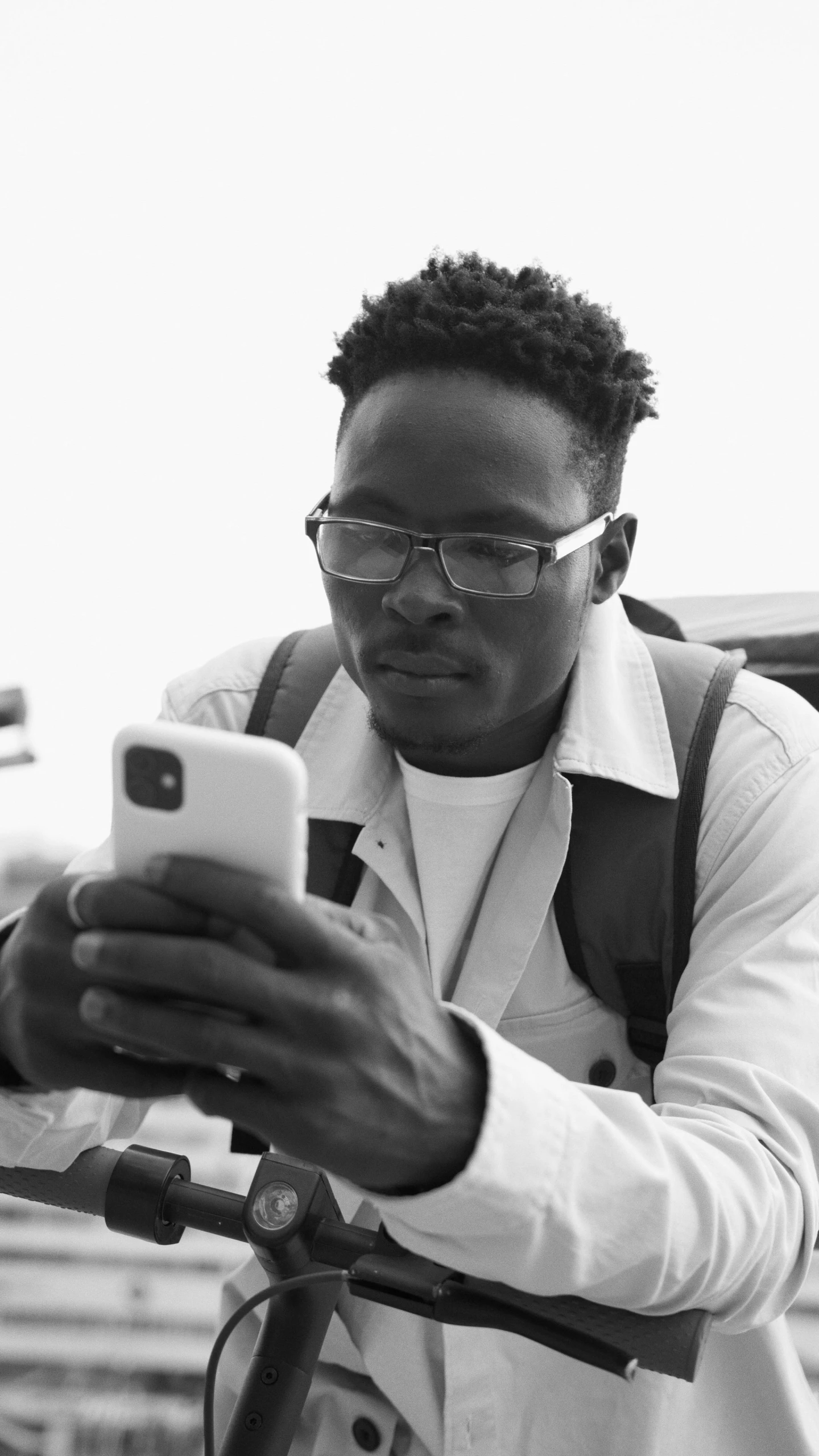 a man in white shirt using cell phone on rooftop