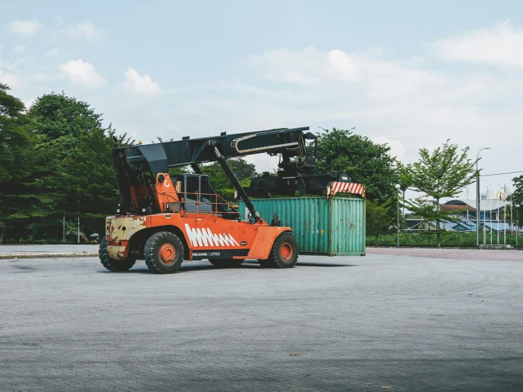 a large fork lift sitting in the middle of a lot