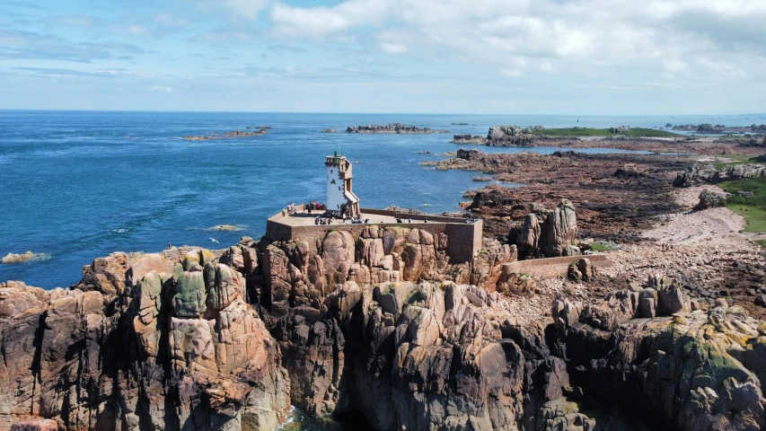 man standing on rocks looking out at the ocean