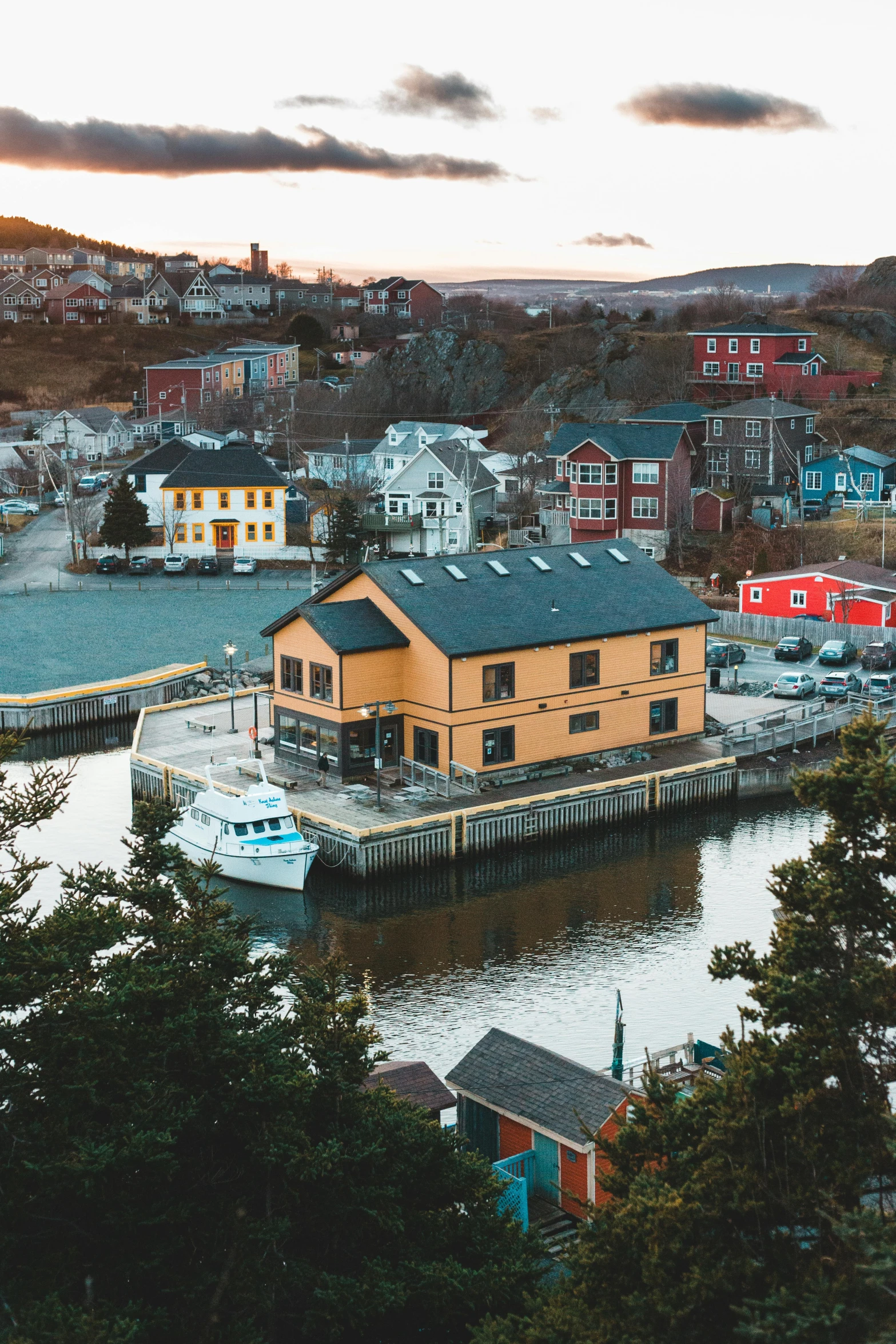 a boat dock surrounded by houses on a lake