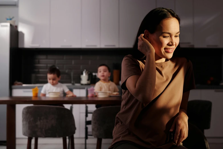 a woman in brown is talking on her phone