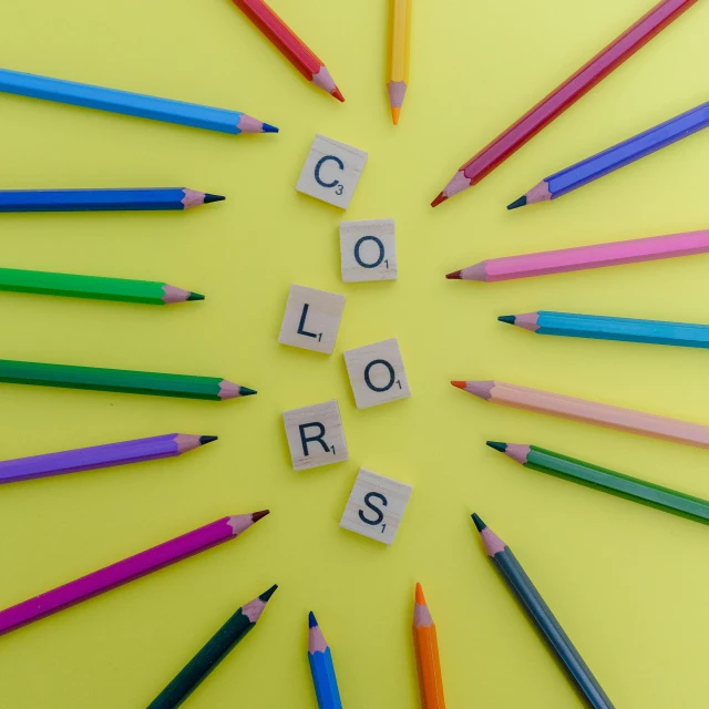 a circle made from colored pencils and words spelling colors