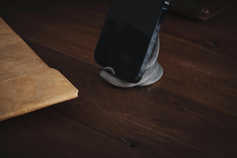 a cell phone sitting on top of a wooden table