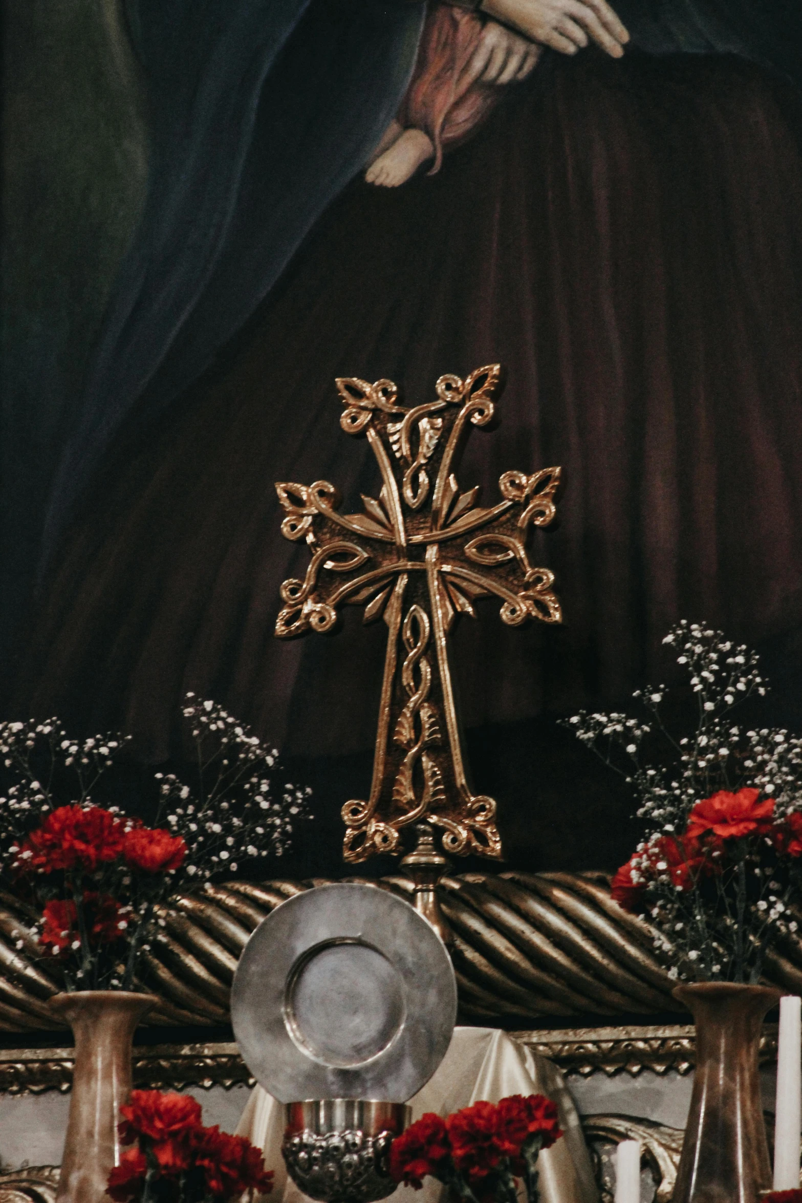 a painting depicting the hand of jesus holding a golden cross