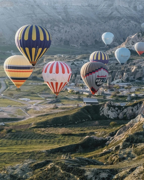 a sky view shows several  air balloons in the sky