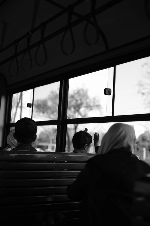 a couple of women are sitting on a bus