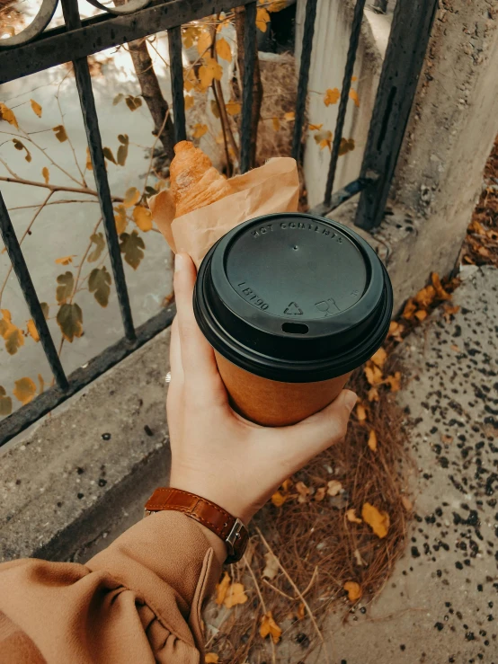 the person is holding up an empty cup