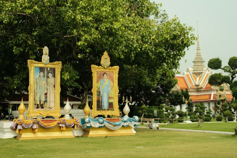 a green field filled with statues covered in art