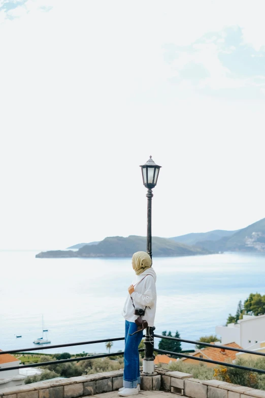 a person looking down at water from a park