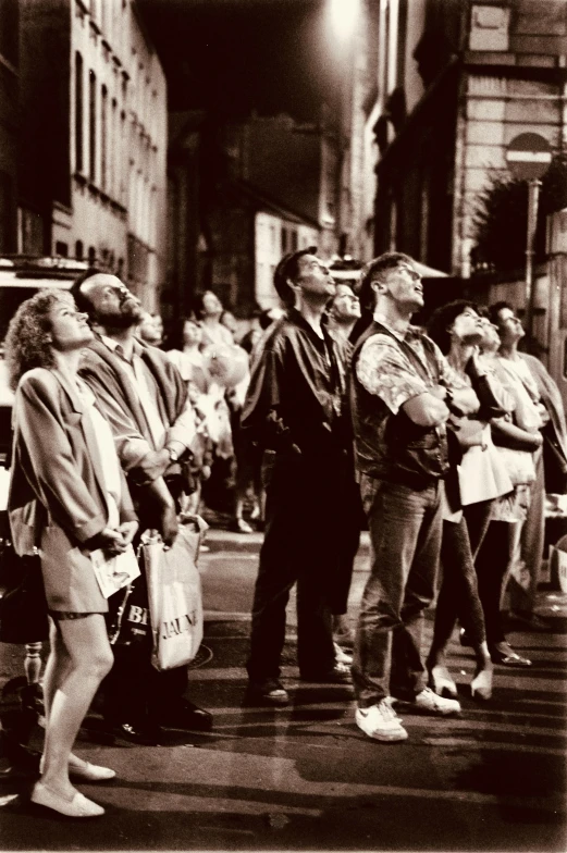 a group of people standing on the street