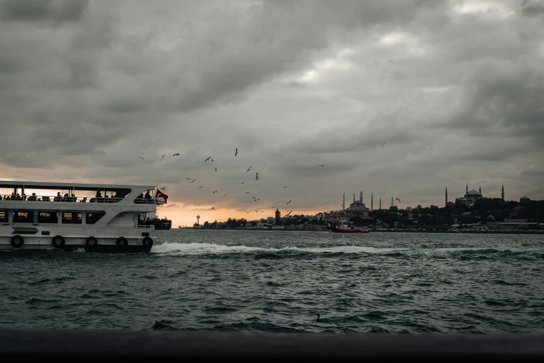 a tour bus traveling through the ocean past a group of people