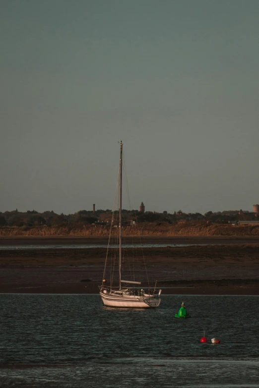 a white boat is on the open ocean water