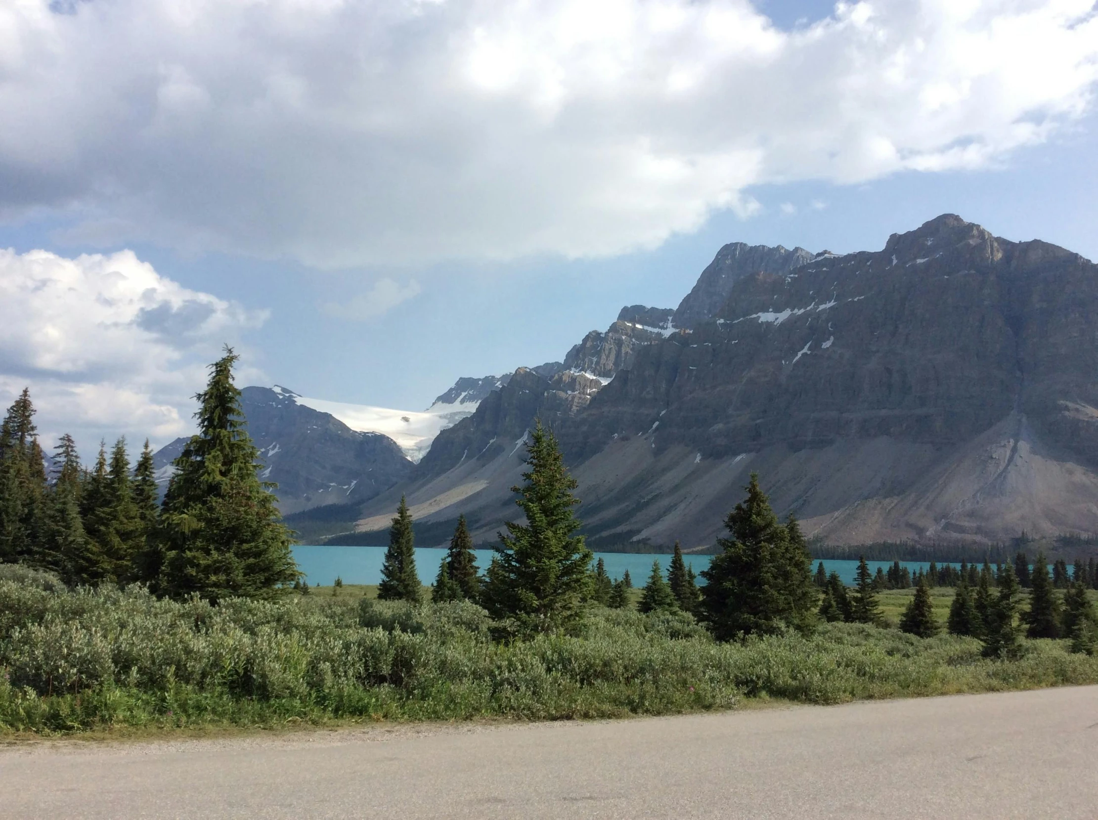 a picture of a road with mountains behind it