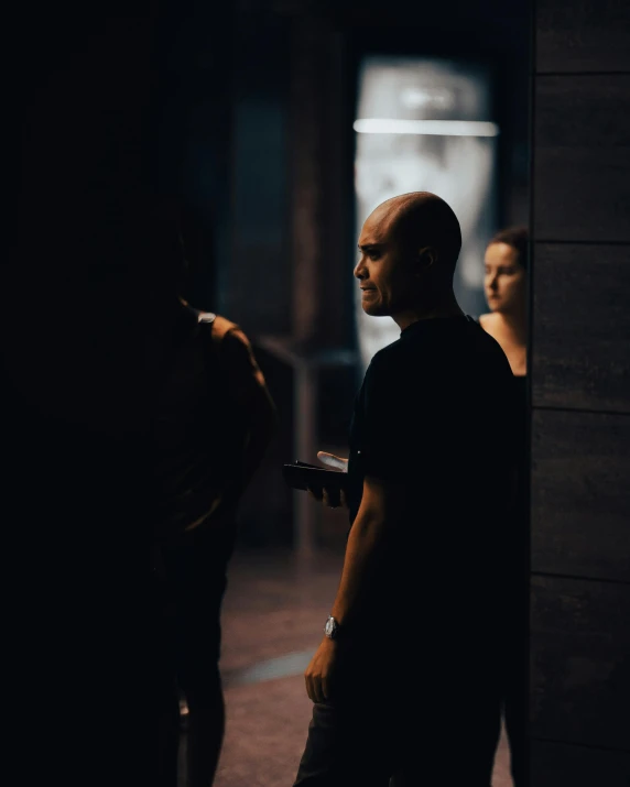 a man is standing in a building with a cellphone