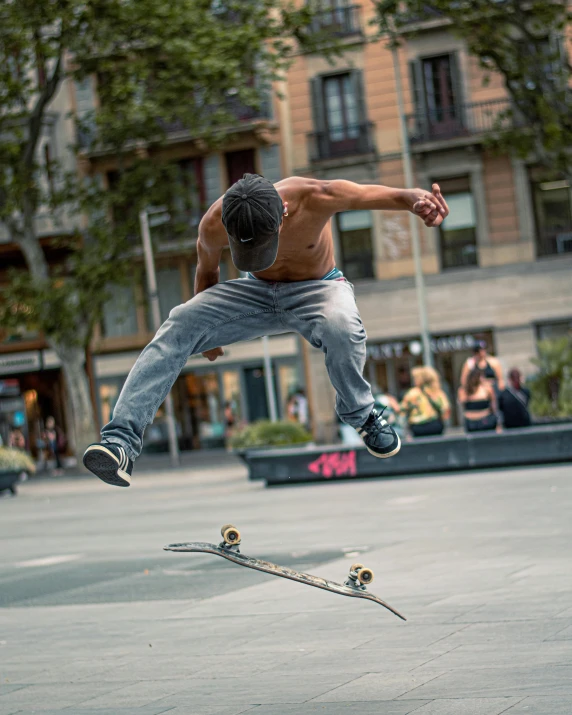 a man doing skateboard tricks while others watch him