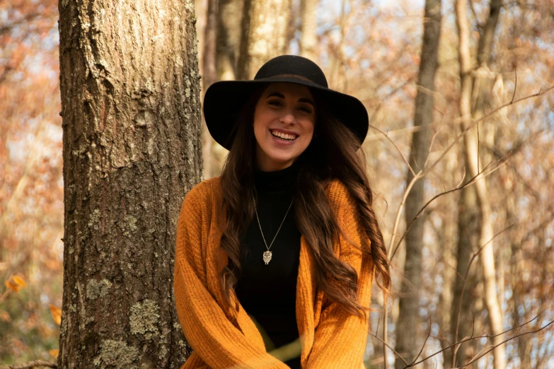 a woman standing in the woods posing for a po