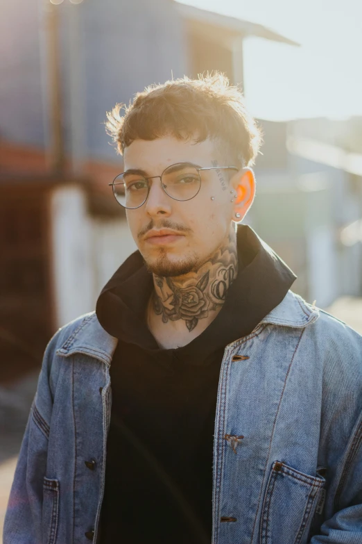 a man with glasses wearing a blue jacket