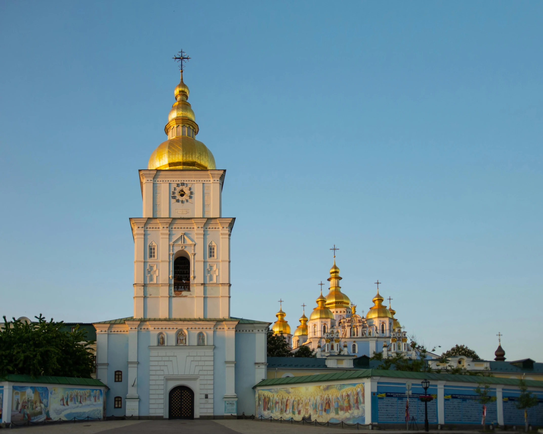 a large tall clock tower sitting above a small church