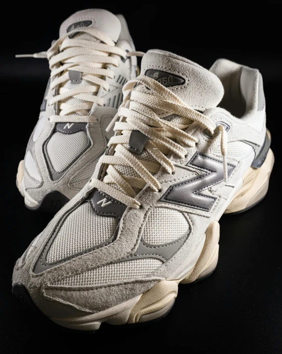 a pair of sneakers with white and beige laces