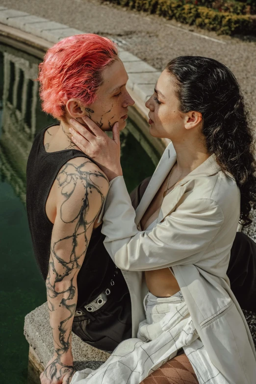 two women with tattoos posing for a po