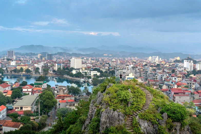 view of the mountains, buildings and a river in a city