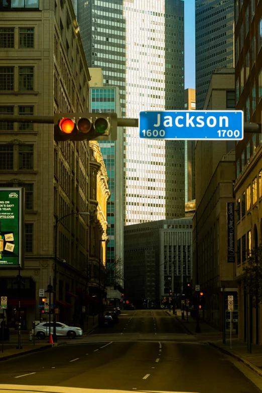 street sign hanging above the city on a light post