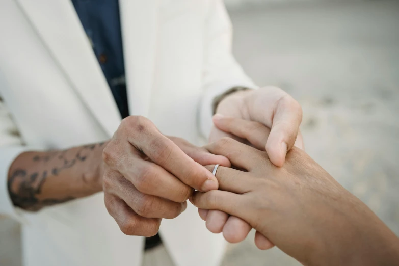 an engaged couple holding hands while standing near each other