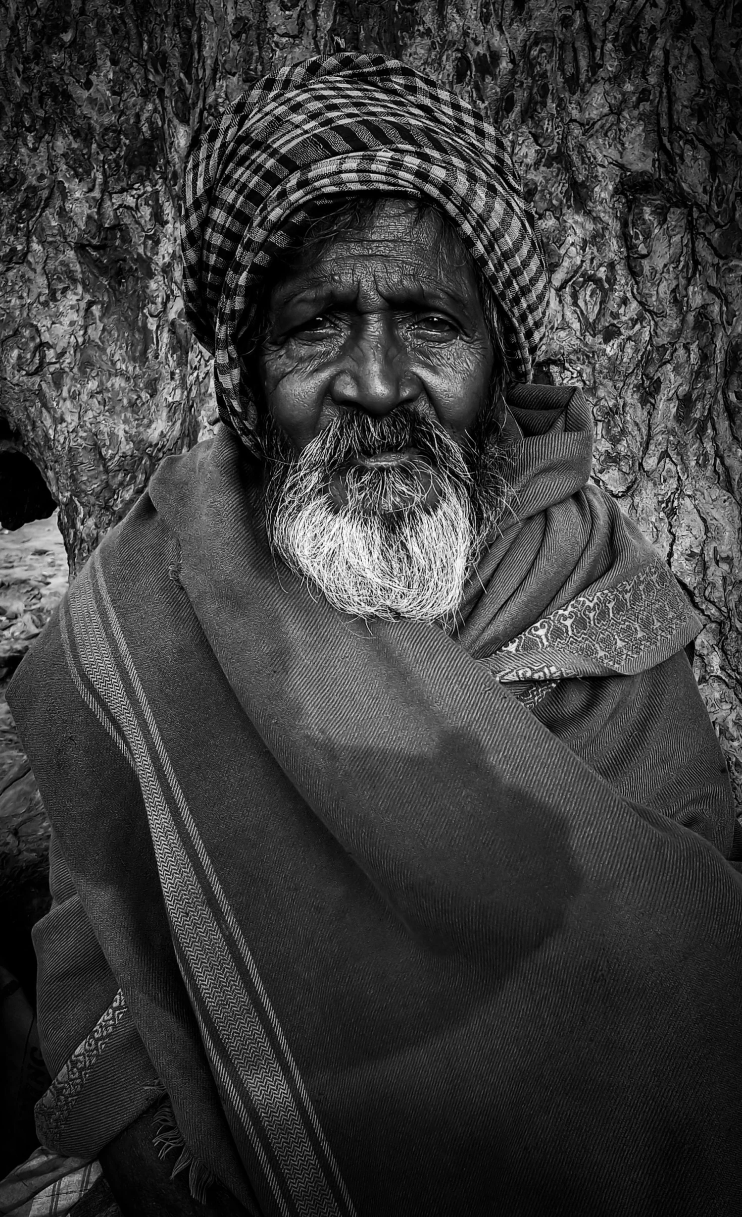 black and white po of man wearing a headscarf