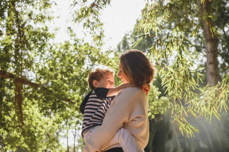 a woman holding a boy in her arms