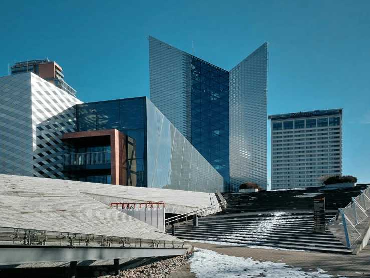 two buildings in front of them with mountains in the back