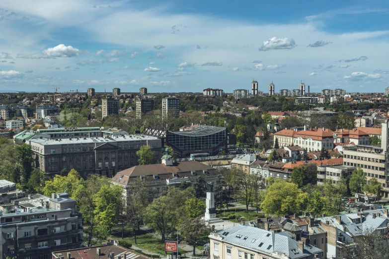 a city with buildings and tall rises above trees