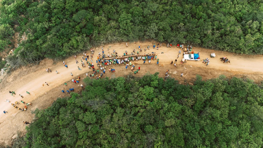 several people are on dirt hills, standing and sitting